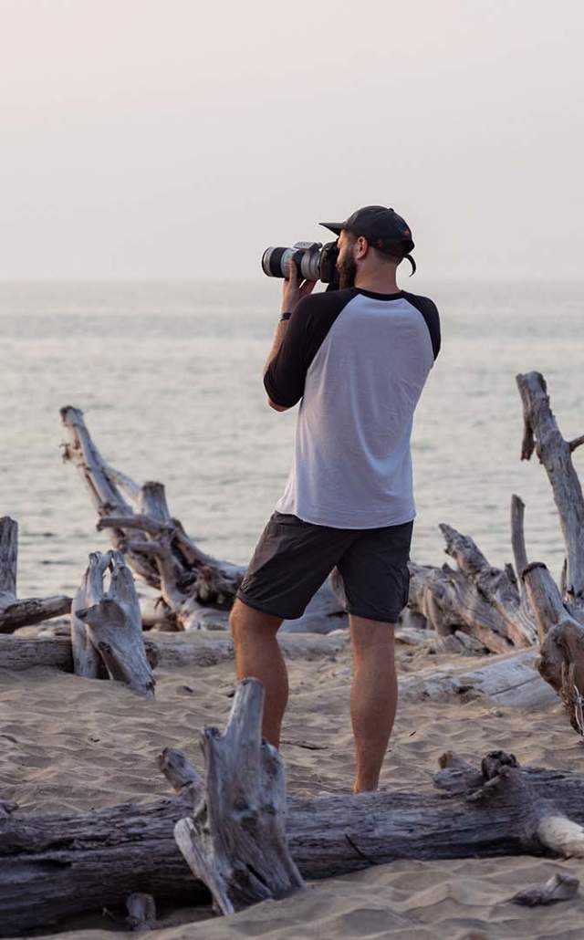 Photographer taking a photo at Whitefish Point, located in the Upper Peninsula of Michigan