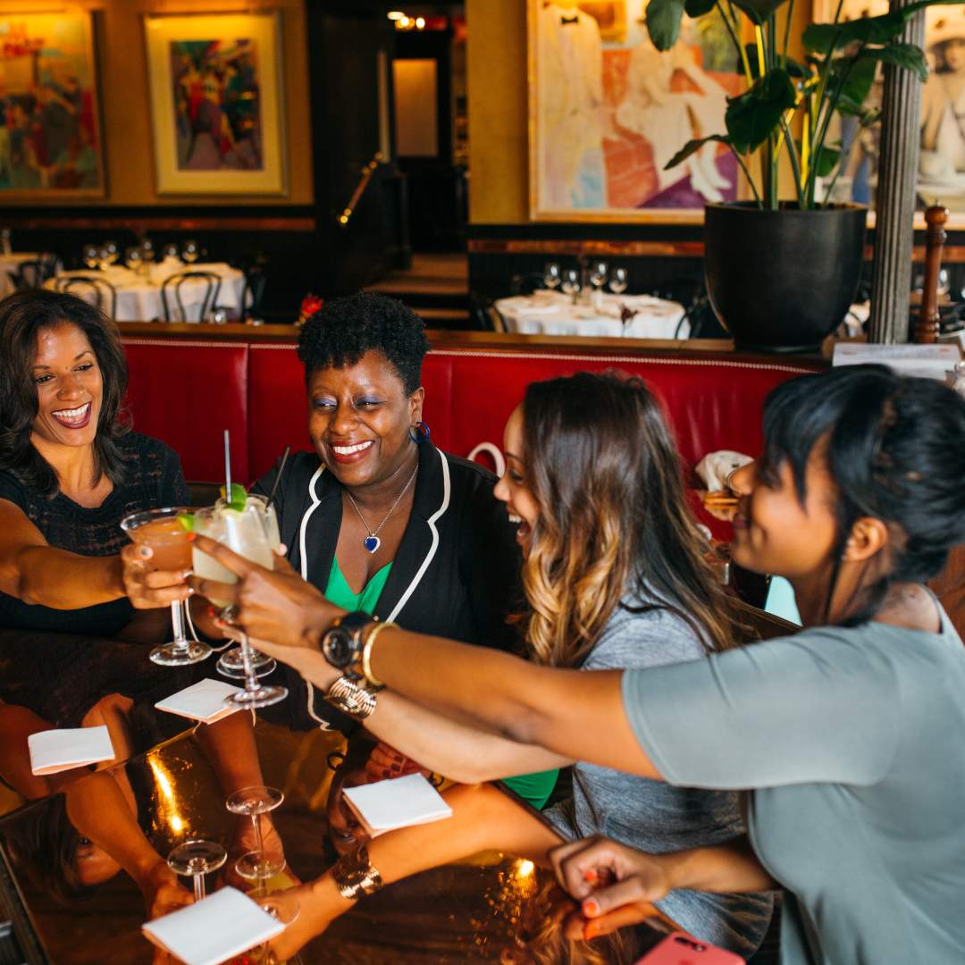 Diverse group of convention attendees enjoying dinner.