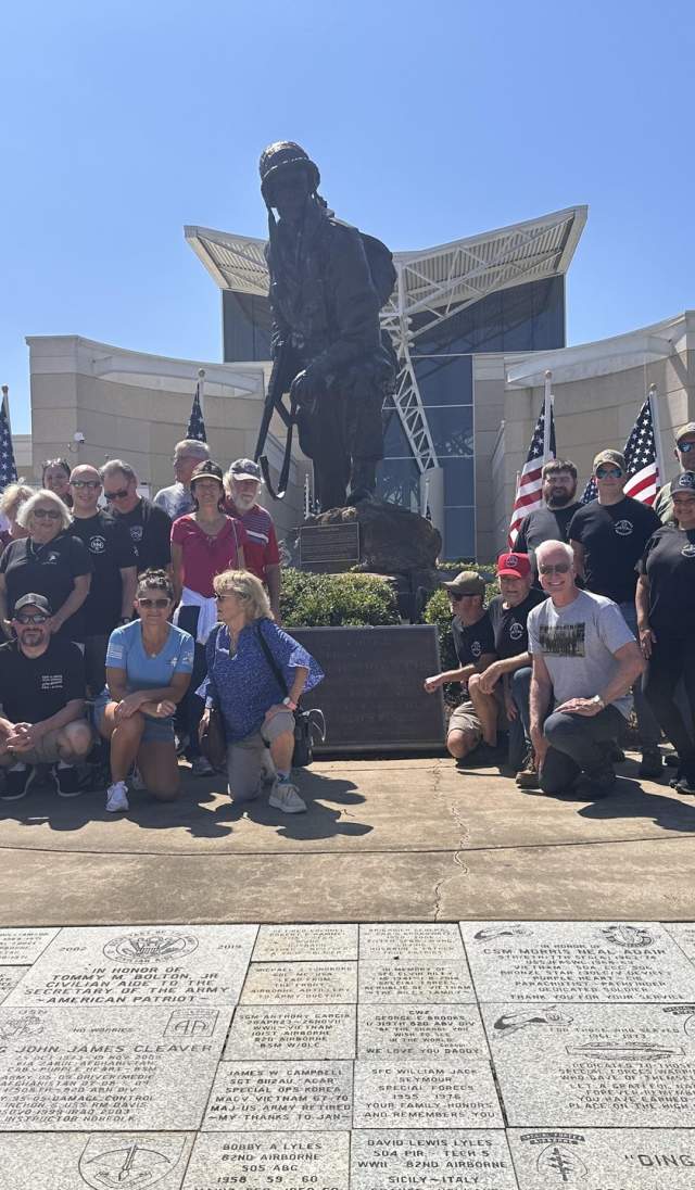 Military reunion group gathered in front of the Airborne & Special Operations Museum statue in Fayetteville, North Carolina