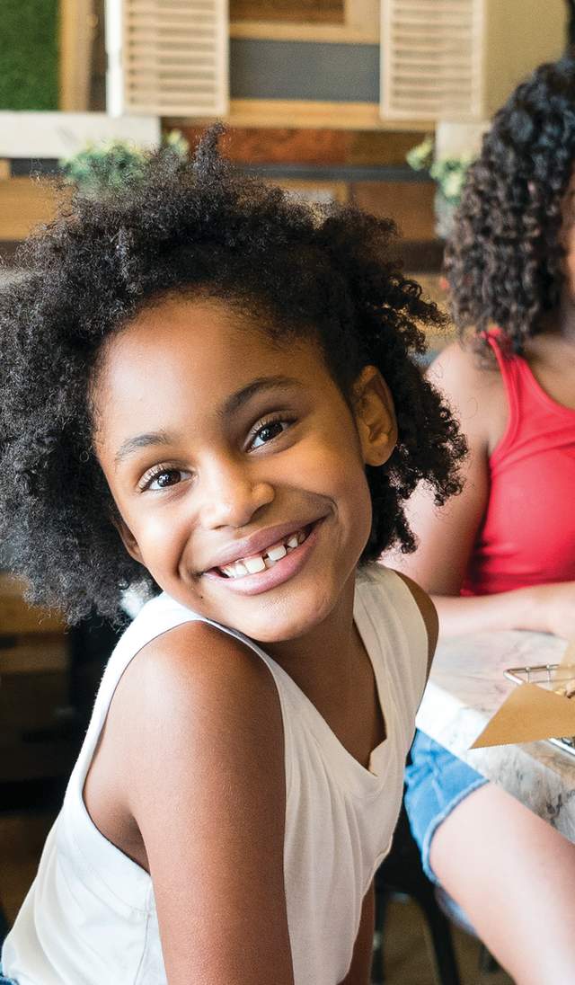 Little girl smiling at Fayetteville Pie Company, located in Cumberland County, North Carolina where she enjoys the best pies in North Carolina.