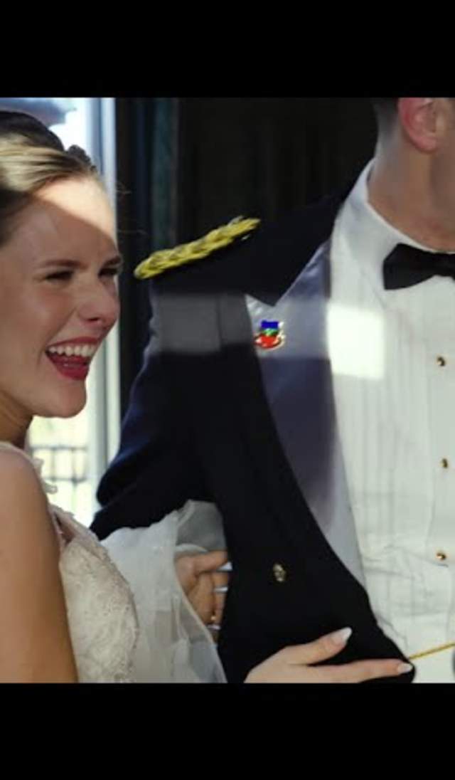 Bride and groom laughing together during their wedding in Cumberland County, NC, with the groom in a formal military dress uniform and the bride in a white gown and veil.