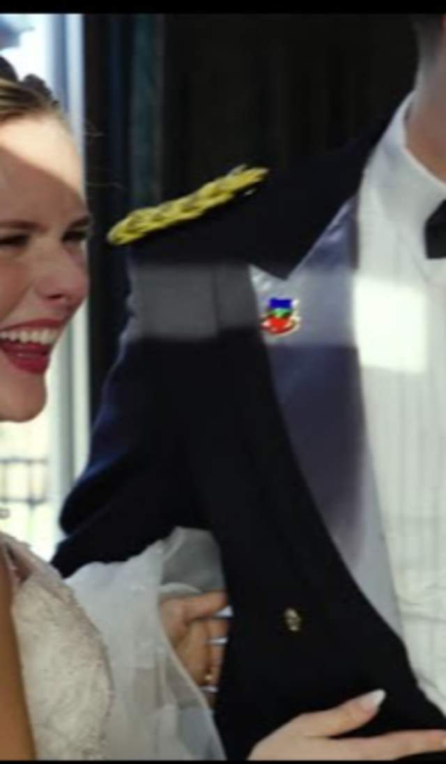 Bride and groom laughing together during their wedding in Cumberland County, NC, with the groom in a formal military dress uniform and the bride in a white gown and veil.