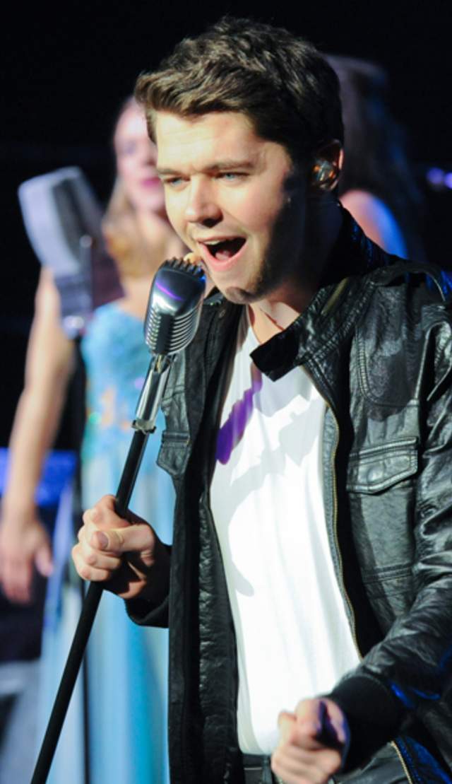 Celtic Thunder Singer performing a solo on stage