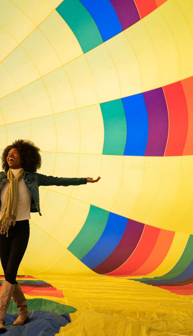 A woman inside of a hot air ballon