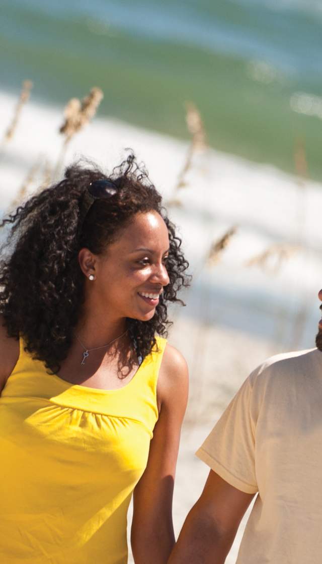Couple enjoying a walk on the beach