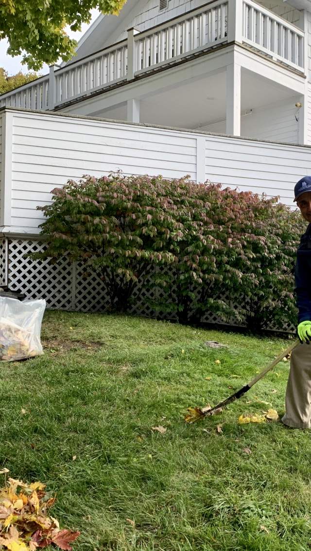 man raking leaves