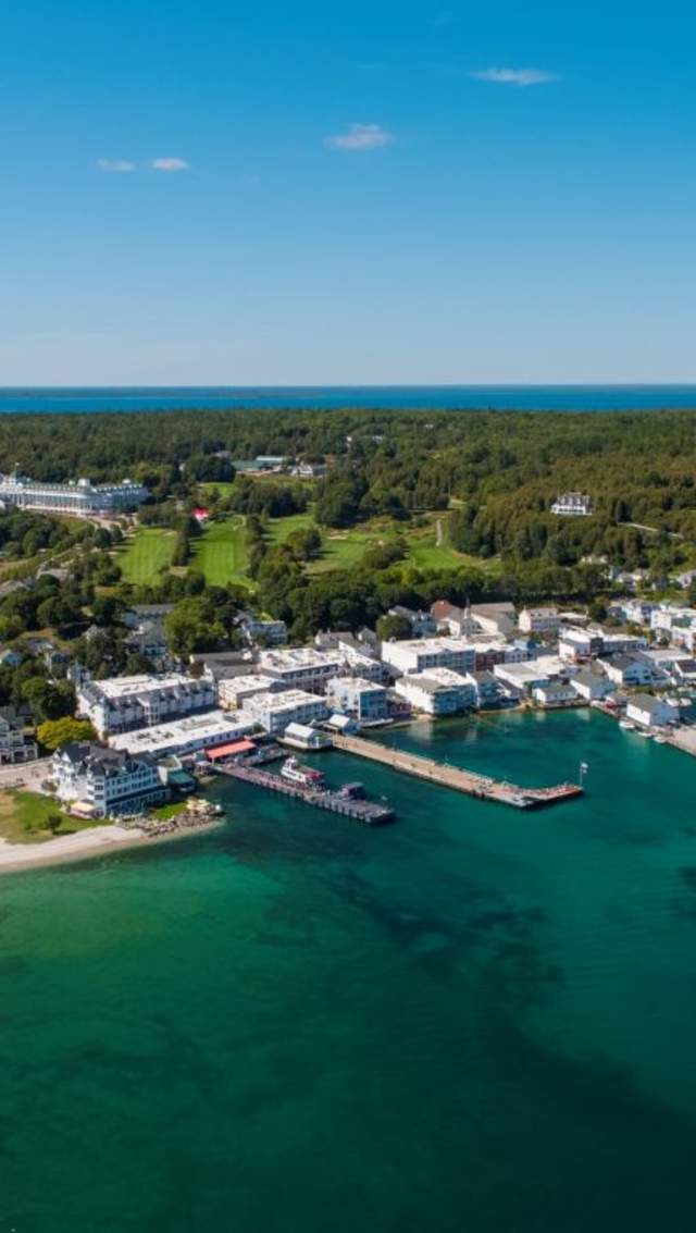 Aerial drone view of downtown Mackinac Island with Grand Hotel, Fort Mackinac and the Jewel golf course