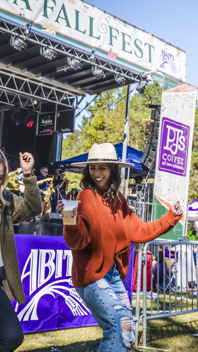 Two women dance beside the stage at Abita Fall Fest.