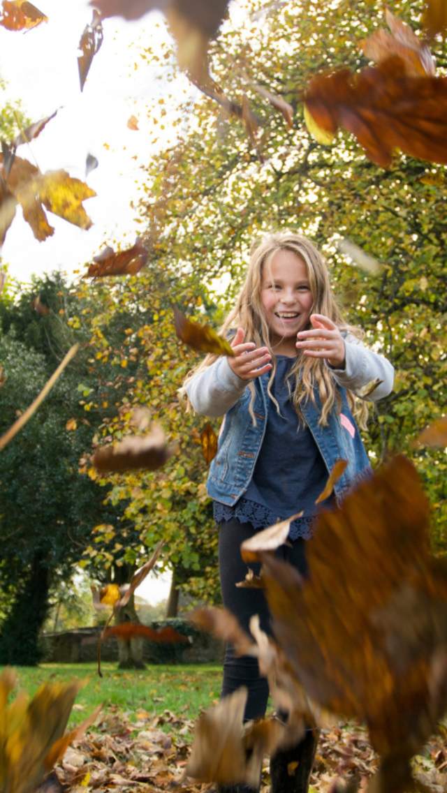 Girls playing in Autumn Leaves