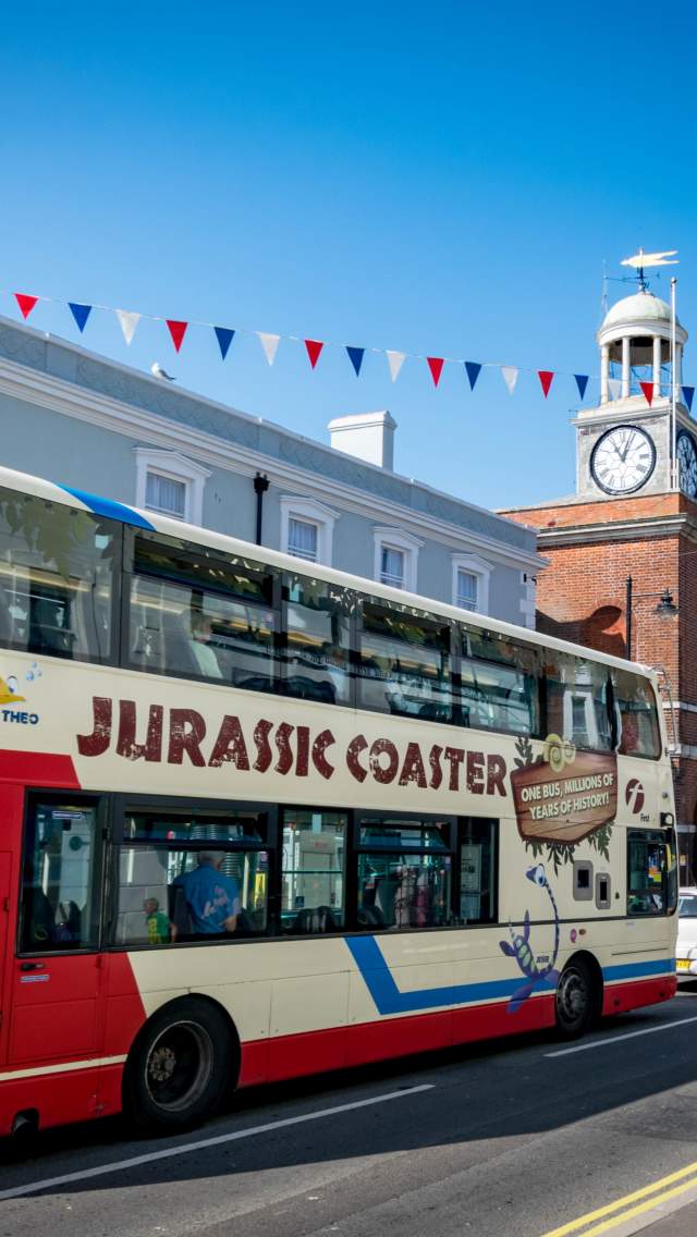 Jurassic Coaster bus making it's way through Bridport town centre, Dorset. Copyright James Loveridge Photography