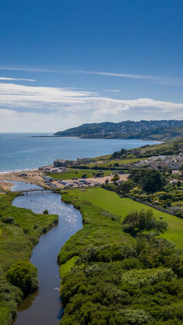 Aerial view of Charmouth beach looking towards Lyme Regis, Dorset. Copyright James Loveridge Photography