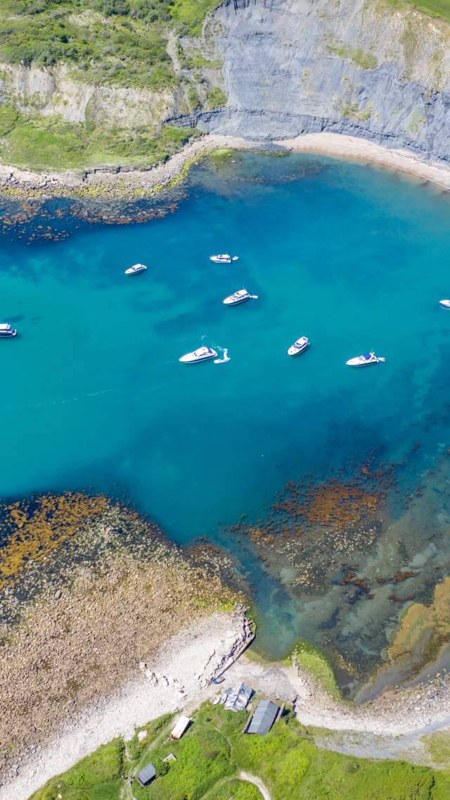 Drone image of Chapman's Pool with anchored boats in the bay. Copyright James Loveridge Photography