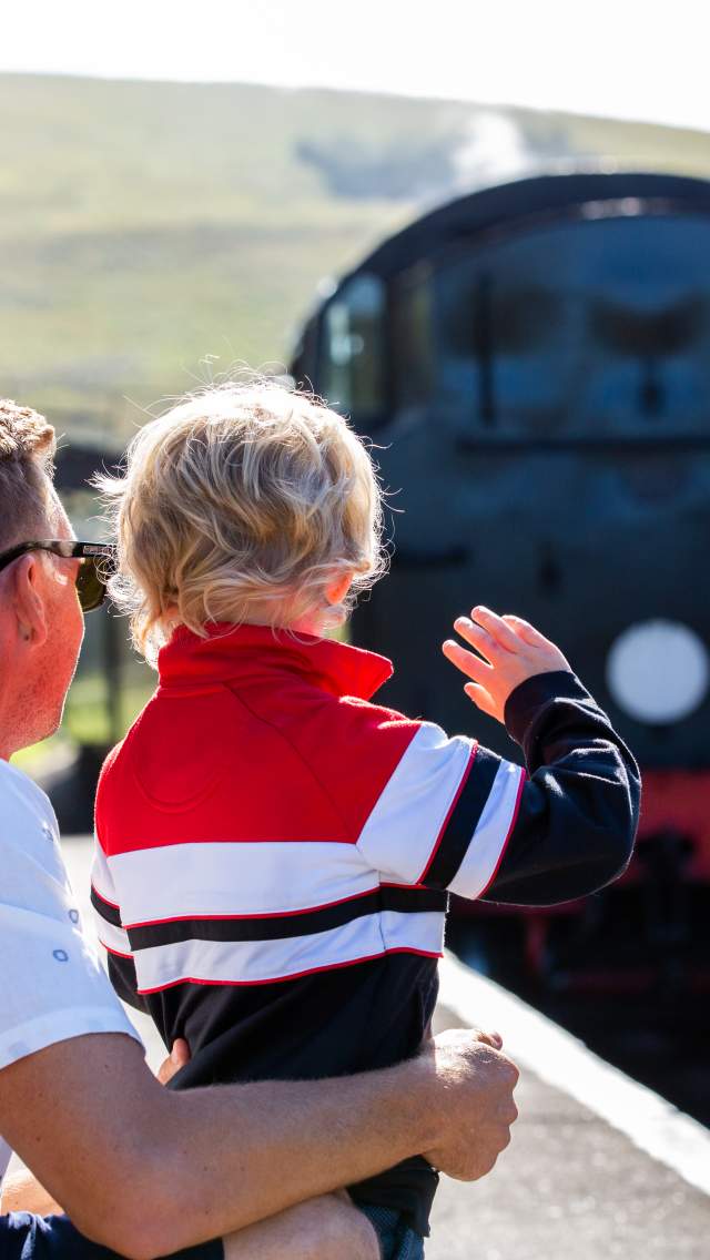Father and son at Norden Station near Corfe Castle waiting for a Swanage Railway train