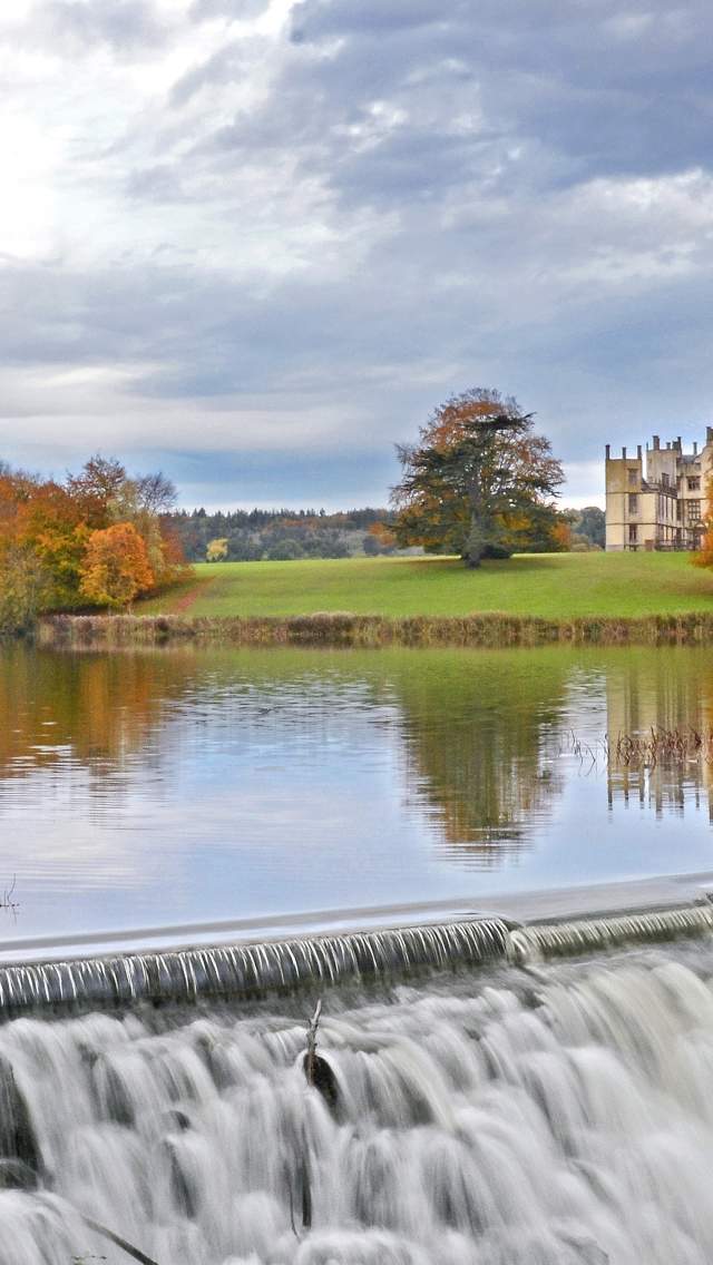 Sherborne Castle lake and water cascade in autumn