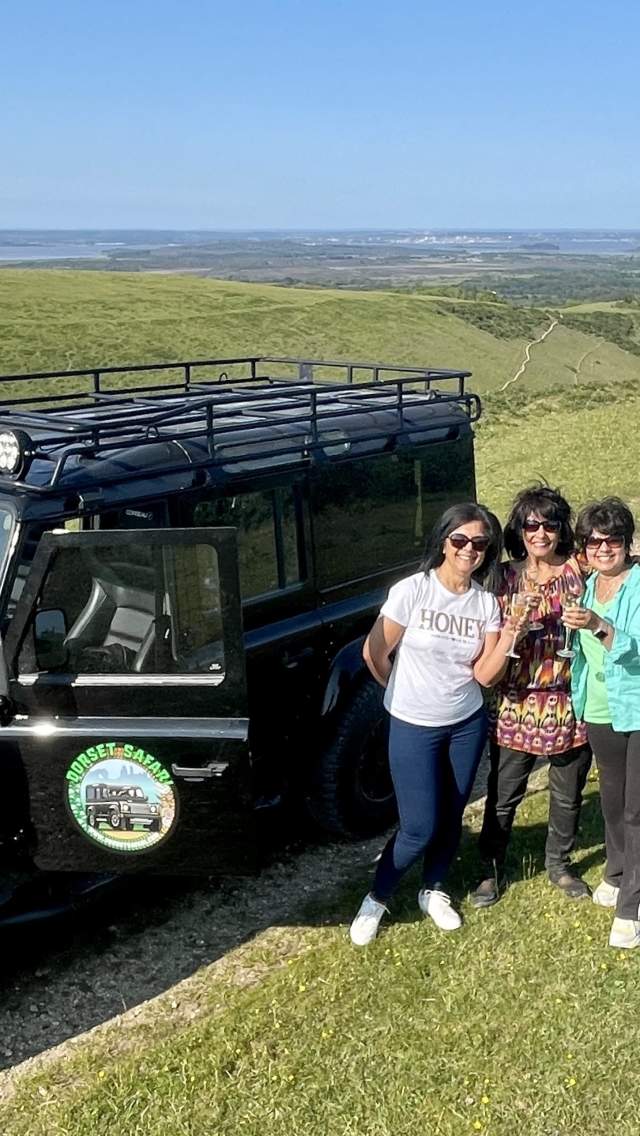 3 Women standing next to a Dorset Safari 4X4 jeep tour vehicle