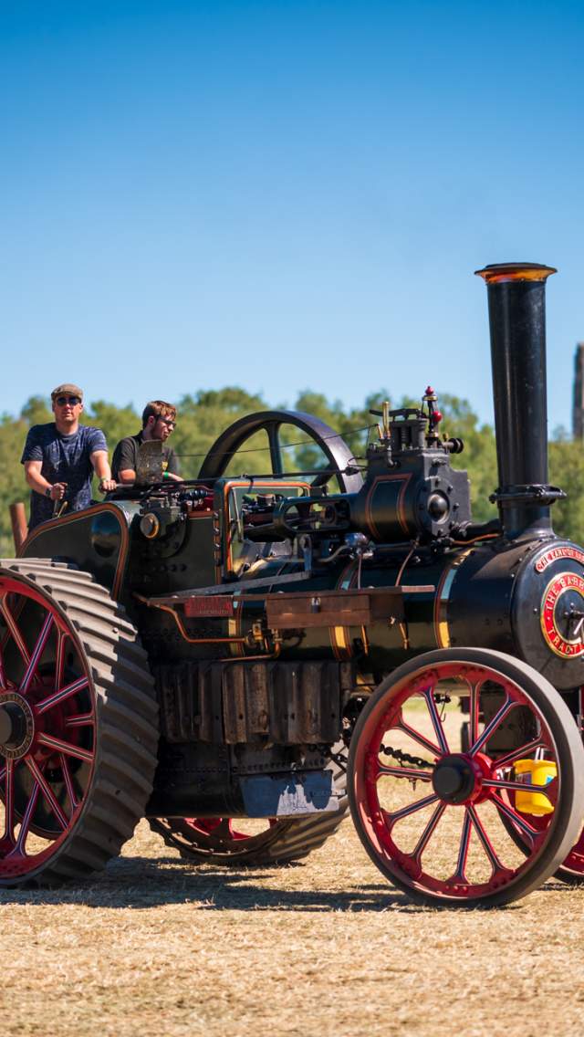 A steam engine with Corfe Castle in the background at the Roads to Rails event in the Isle of Purbeck, Dorset