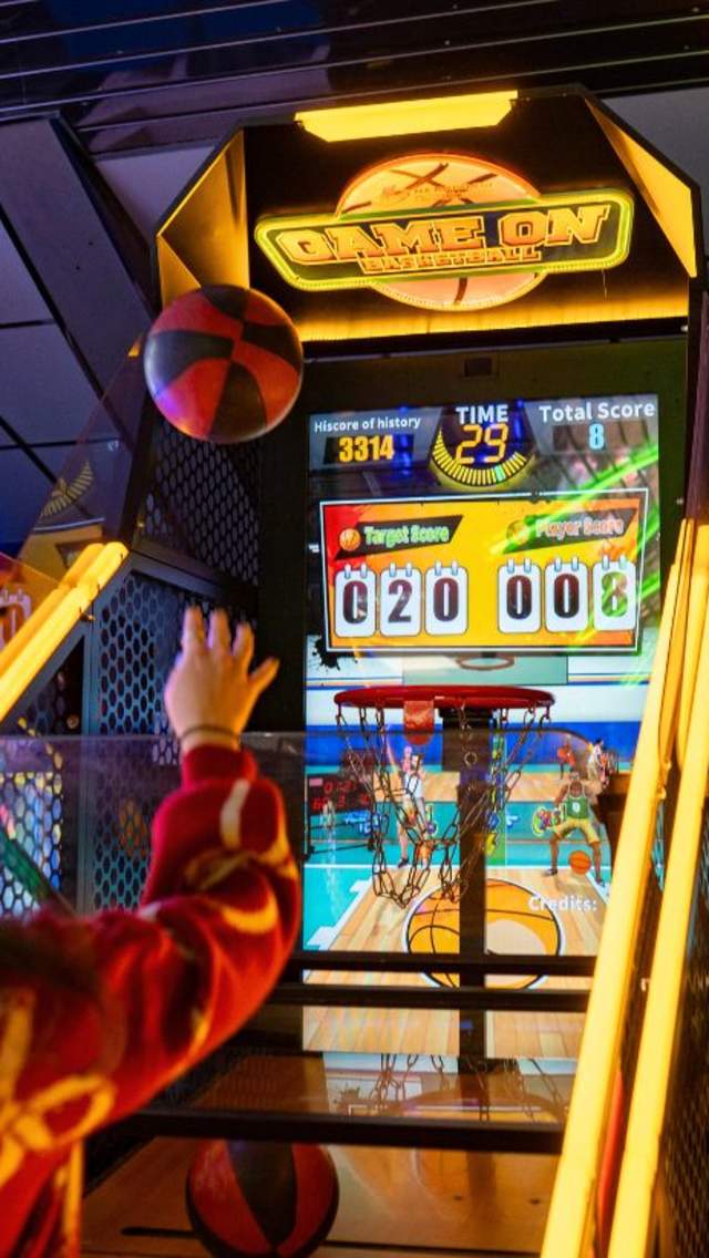 A girl playing on the basketball game at Southside Funfair in Weymouth