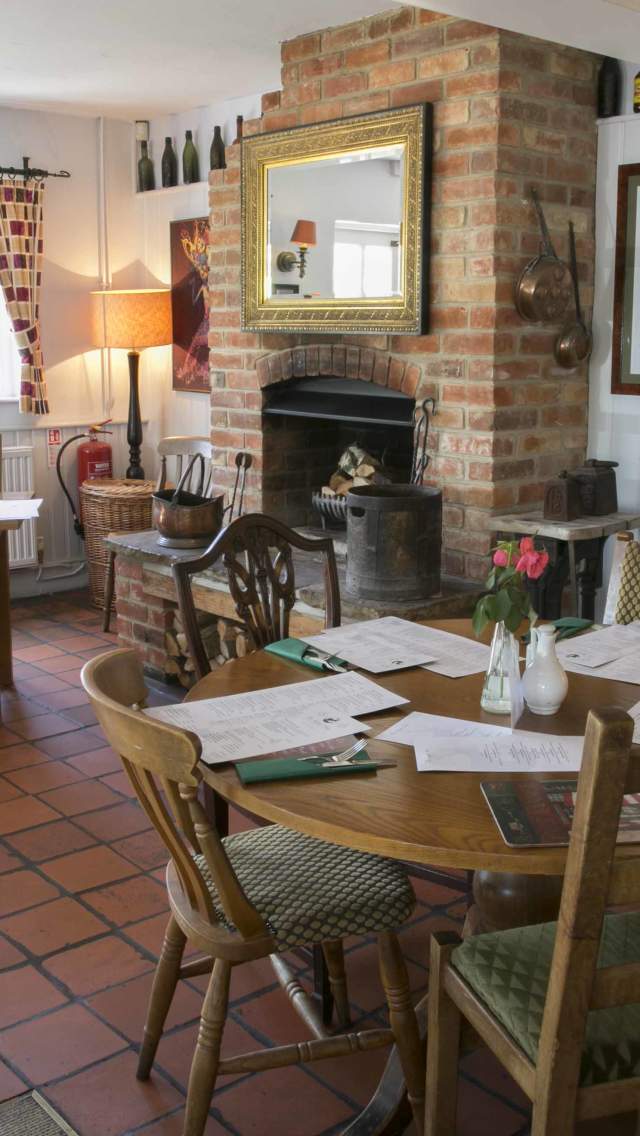 Tables, chairs and log fire at The Kings Arms pub near Wareham in Dorset