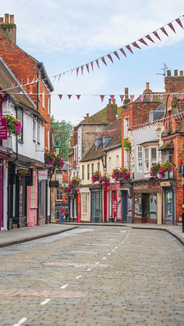 A view down the Bailgate, a historic street lined with colourful shops