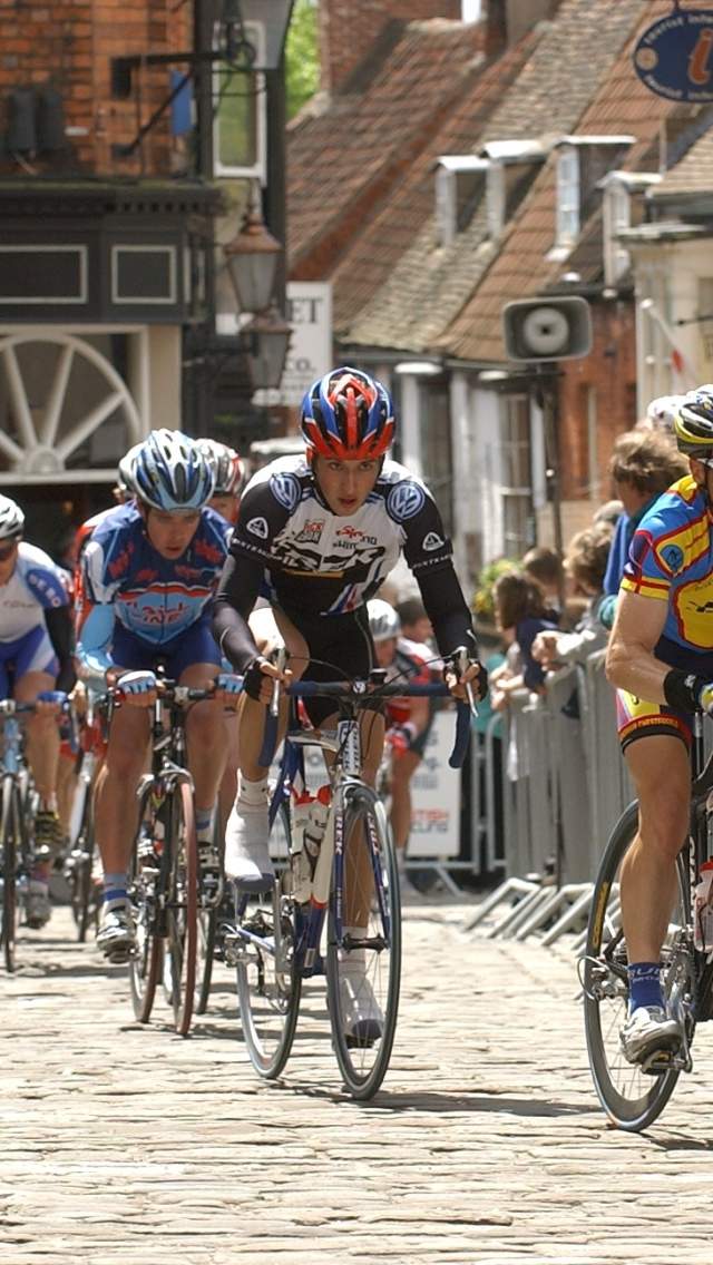 Group of cyclists racing through Lincoln streets