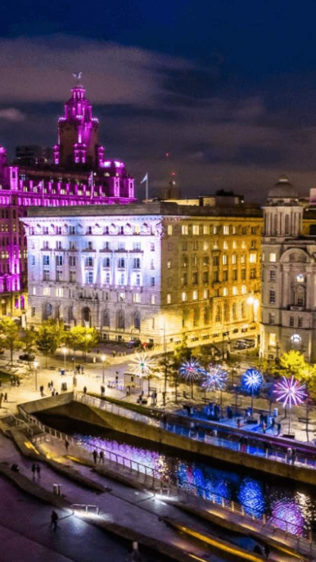 Liverpool Waterfront at night, with the Royal Liver Building bathed in pink light