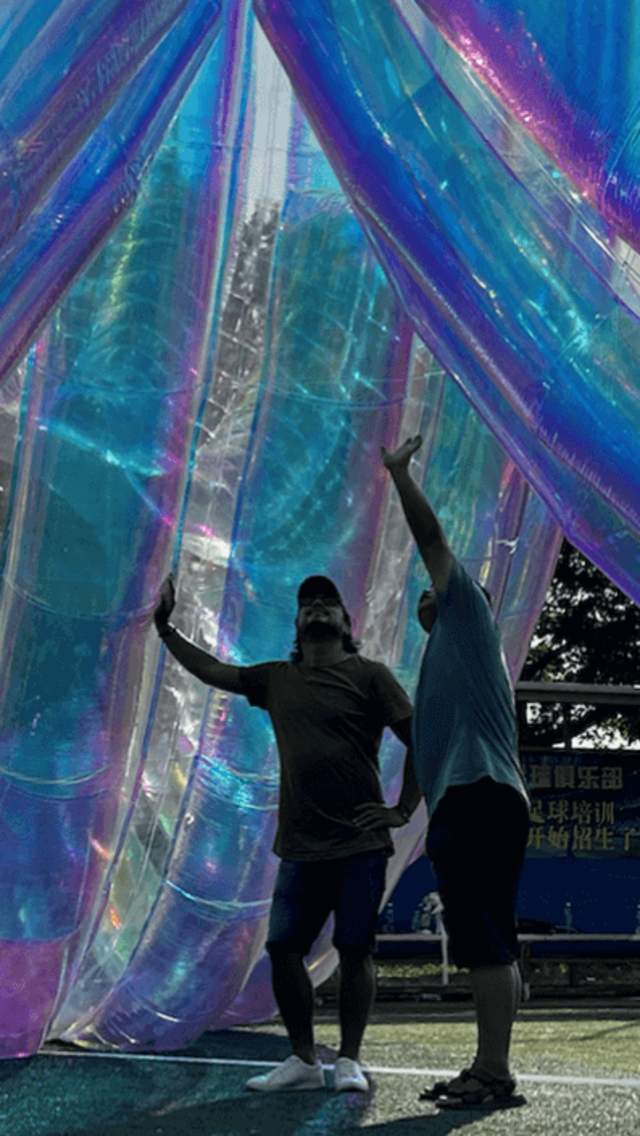 A large inflatable sculpture with two people stood underneath it.
