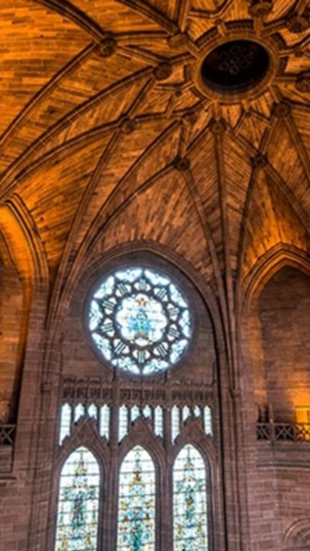 Inside Liverpool Cathedral with a stunning vaulted ceiling and stained glass