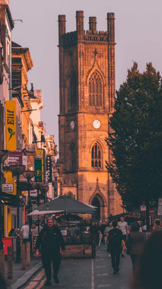 The view looking up Bold Street towards the Bombed Out Church Spire. It could be said to be 'golden hour' during the time of the shot as a golden light falls onto the Church at the top of the street.