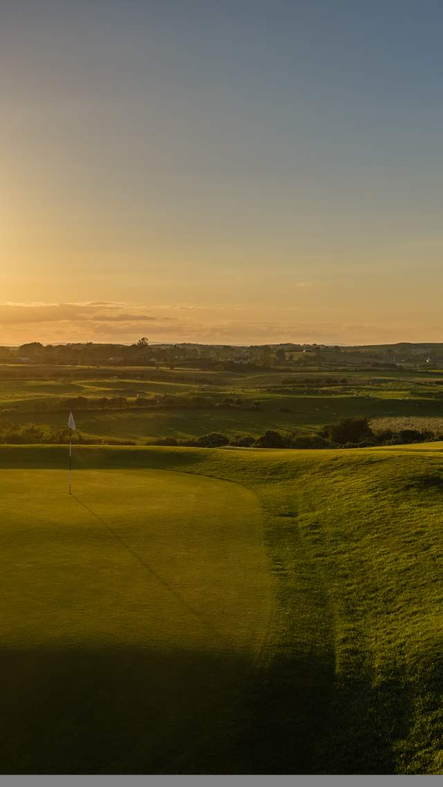 Green at Kirkistown Castle Golf Club at sunset