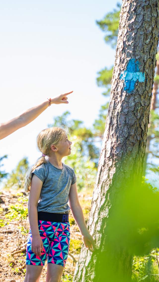 To barn følger blåløype i skogen i Ørje.