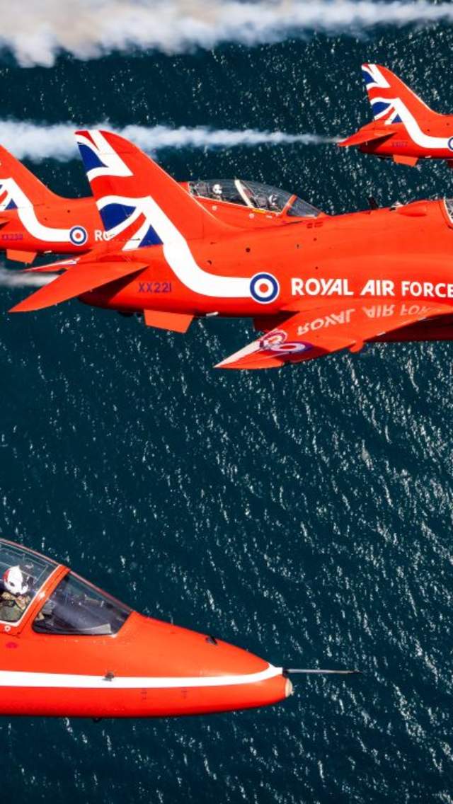 5 Red Arrows flying above open water