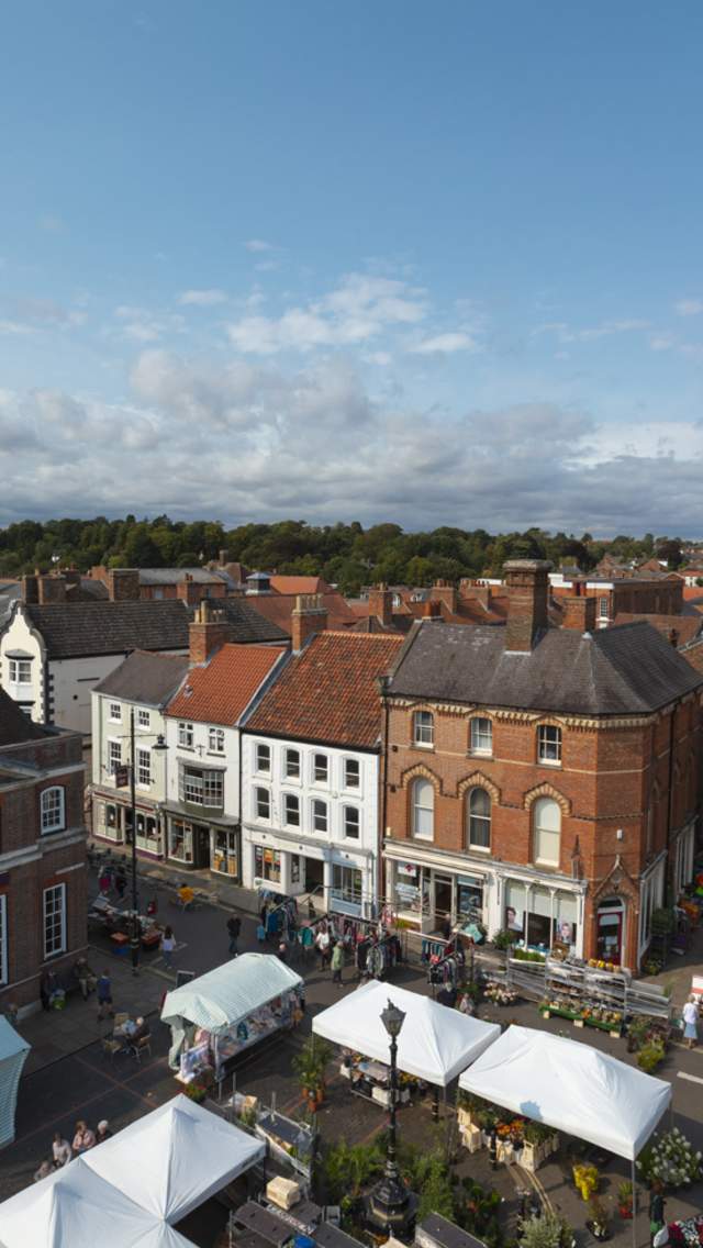 a skyline of Louth with market square below and church in background under blue skies