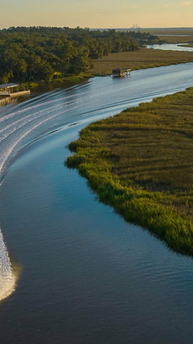 A boat navigates the marshes and waterways in the Golden Isles.