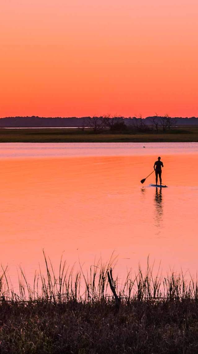 A group paddle boards across the famed Marshes of Glynn on the Georgia coast