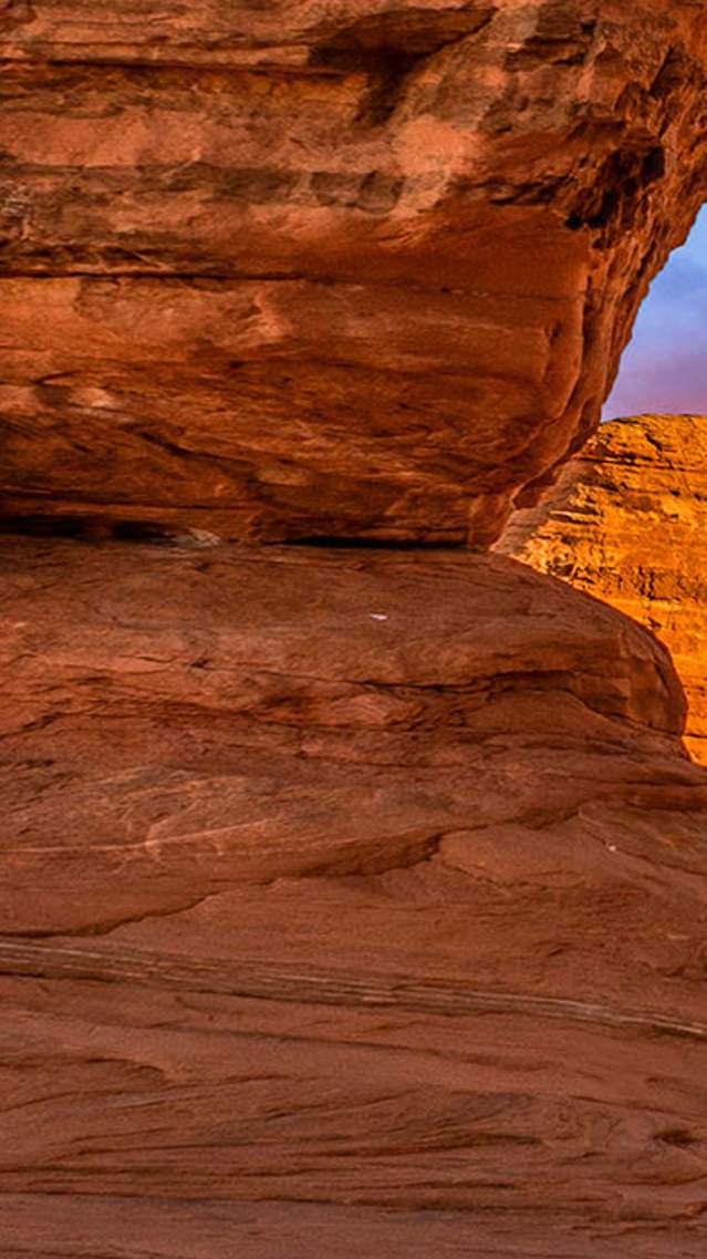 A vibrant sunset over Delicate Arch in Arches National Park.