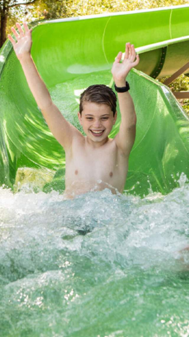 Child splashing down waterslide