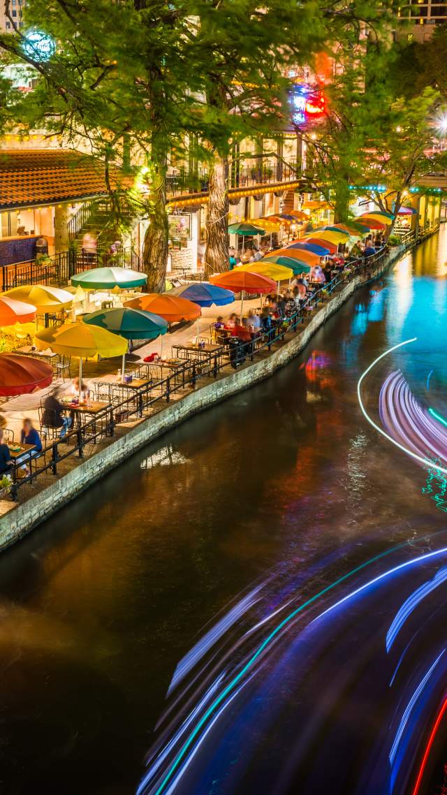 River Walk pathway lit with colorful umbrellas