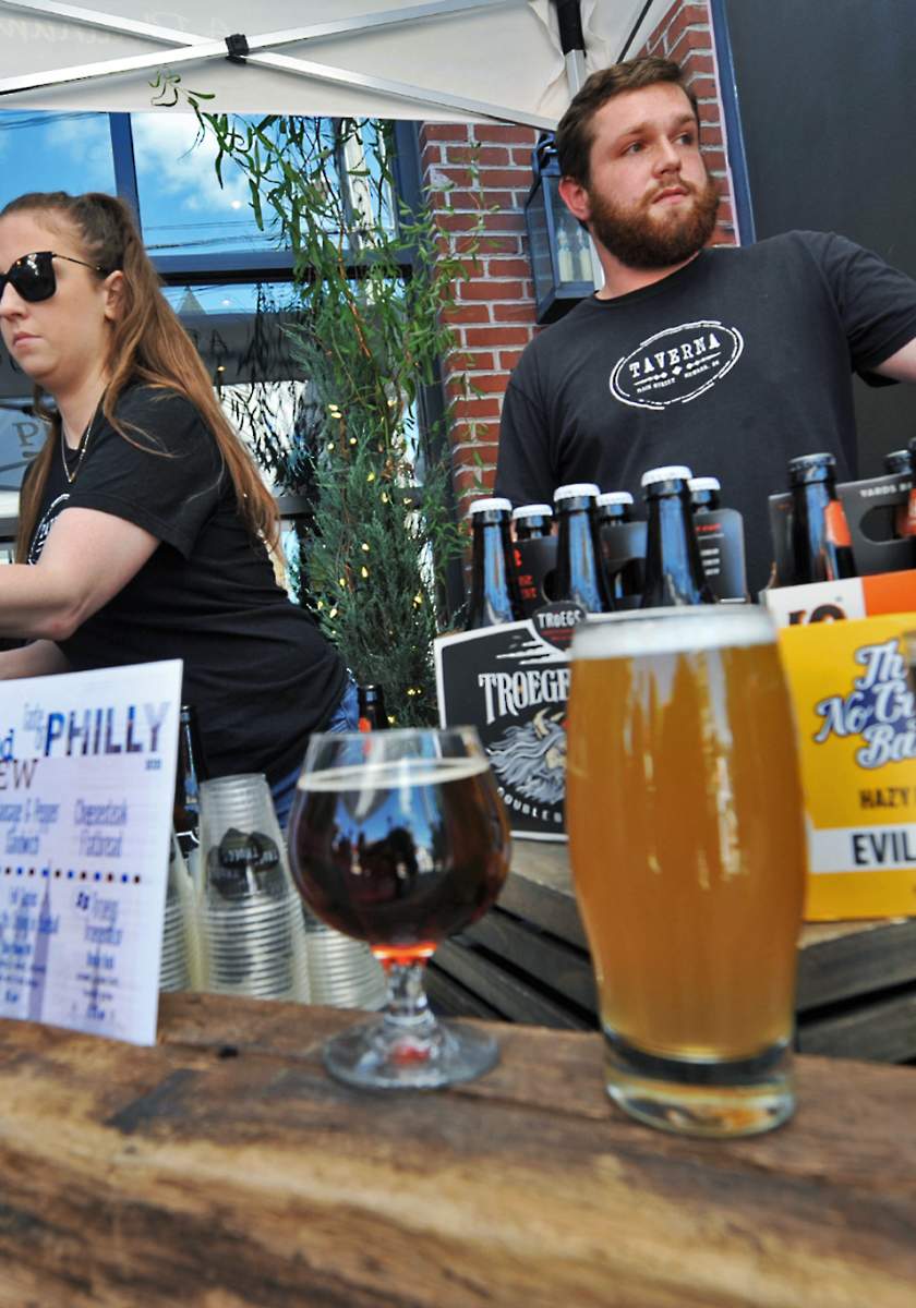 Bartenders serving beer at the Downtown Newark Food + Brew Festival