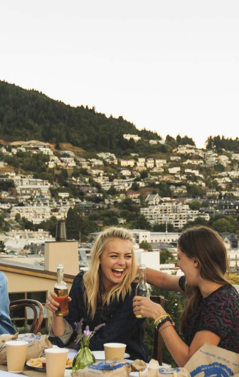 Backpackers dining on Queenstown Lakefront