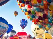 A group of balloons lifting off in a mass ascent at Bristol International Balloon Fiesta - credit Paul Box