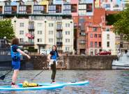 Person stand up paddleboarding in Bristol harbour - credit SUP Bristol