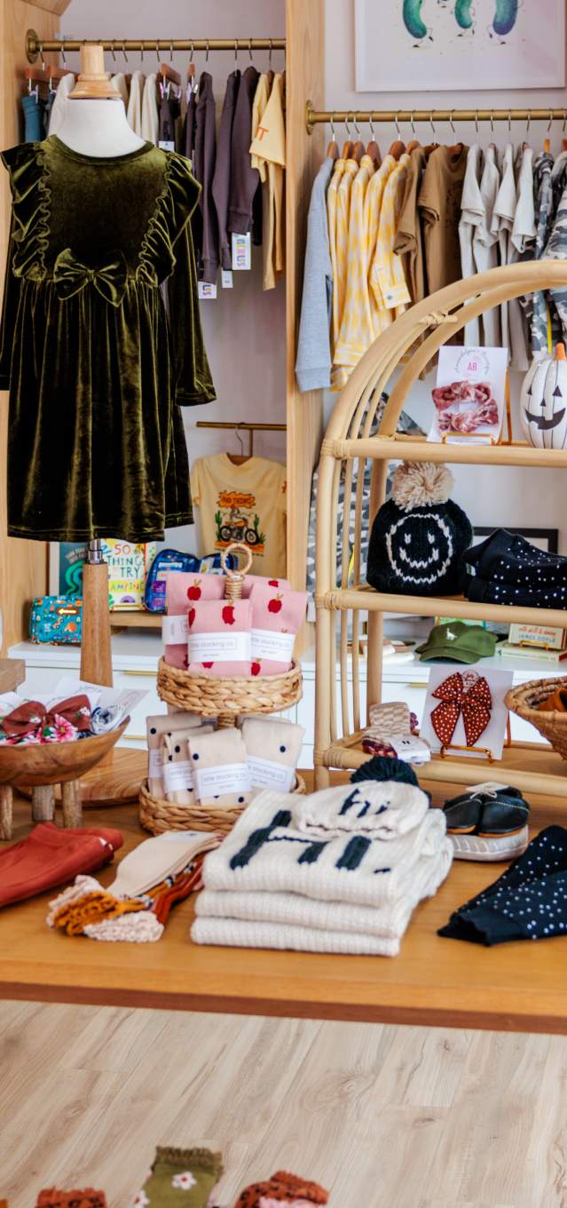 An in-store table display of clothes for children.
