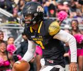 A Bowie State football player runs with the ball in a game