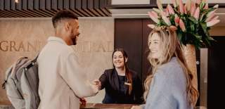 Couple checking in at The Grand Central Hotel