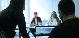 Group of people doing some research on a laptop.