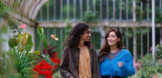 2 girls walking through the Tropical Ravine at Botanic Gardens.