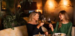 Two ladies drinking wine for Mother's Day