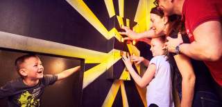 Family enjoying one of the puzzle rooms at Prison Island Belfast.