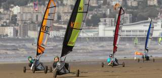 A view of people riding in sail carts on the beach at Weston-super-Mare near Bristol - credit Visit Weston