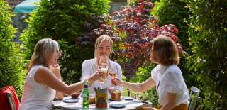 Group of women with drinks in the beer garden at The Swan in Wedmore